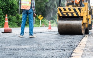 back-view-standing-engineer-small-asphalt-roller-duty-repairing-repairing-asphalt-road-workers-road-construction-industry-teamwork_157563-1-1