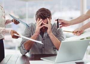 Stressed man frustrated with electronic devices in office